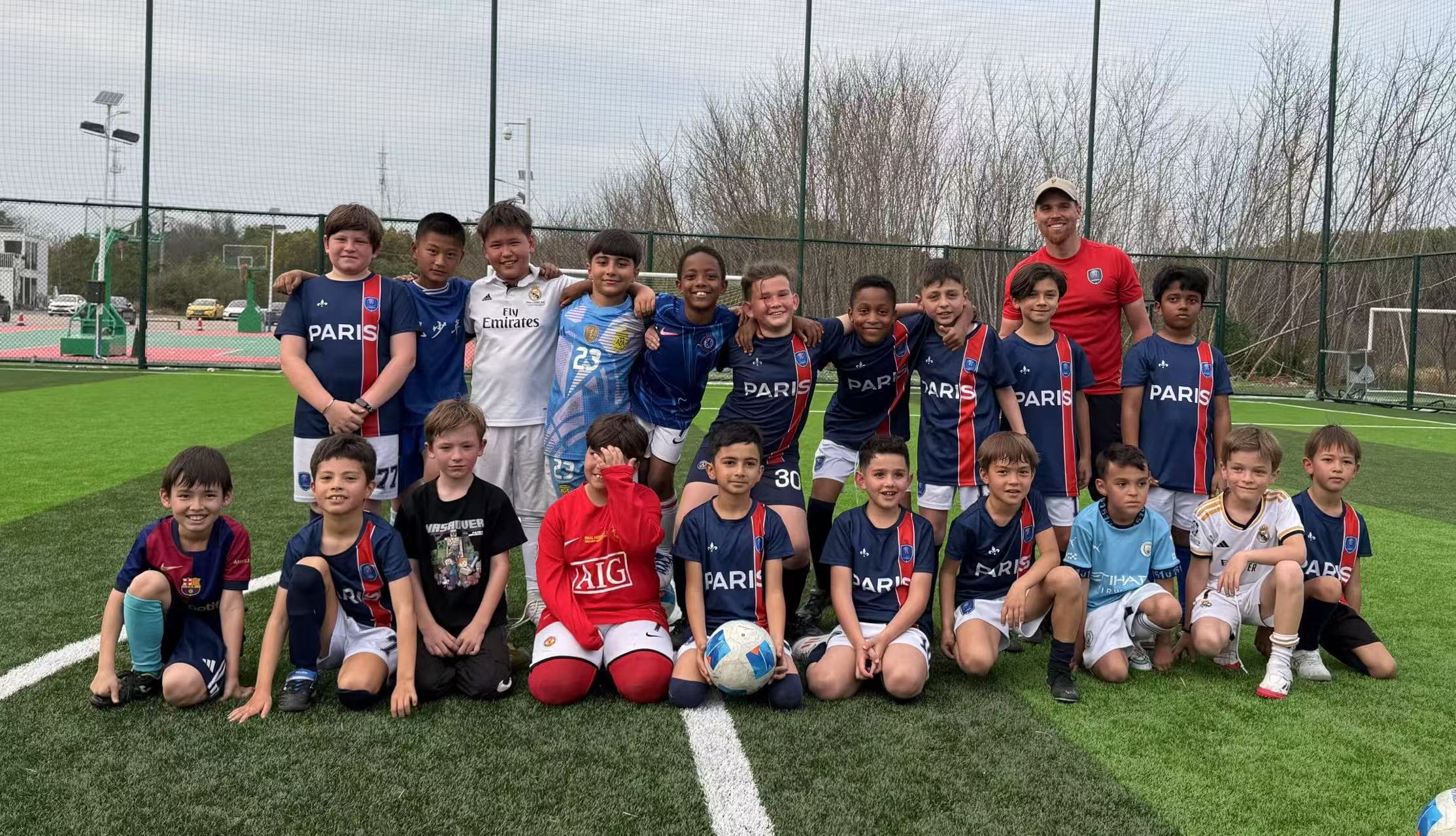 A football on a lush green pitch.