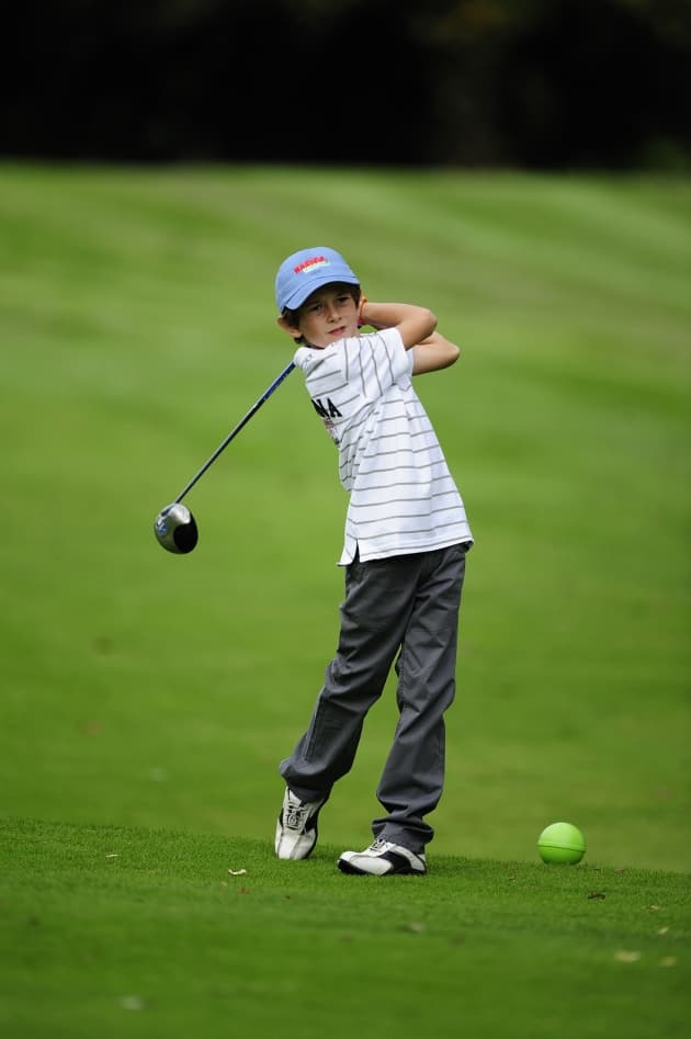 A golf ball on a pristine green near the hole.