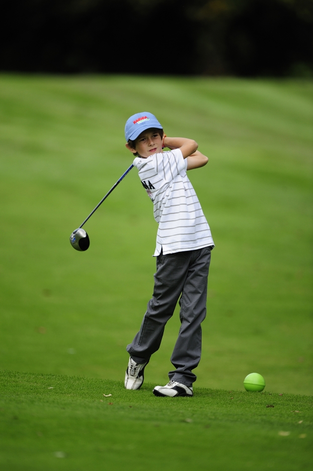 A golf ball on a pristine green near the hole.